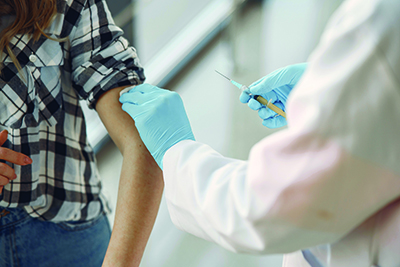woman receiving vaccine in arm from doctor